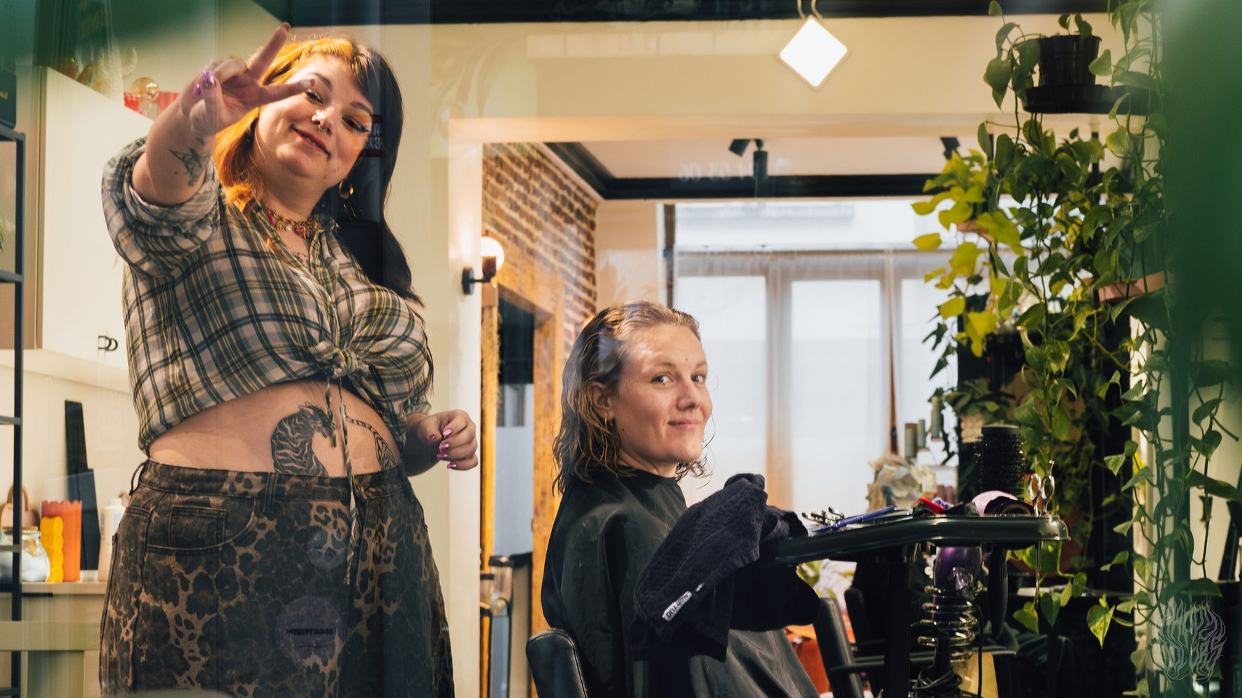 Two people laughing together inside the salon