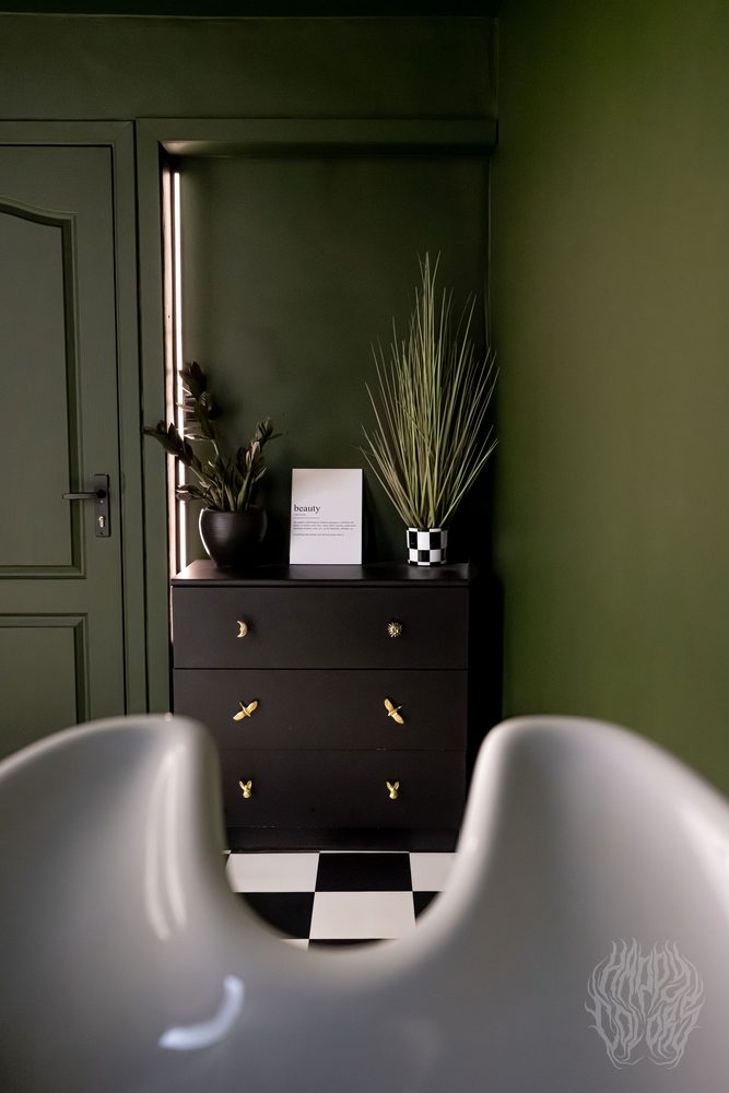 The salon interior with plants and a checkerboard floor
